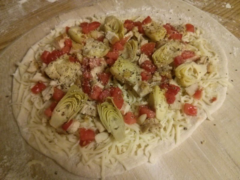 Add chicken, artichokes, tomatoes, roasted garlic and parmesan