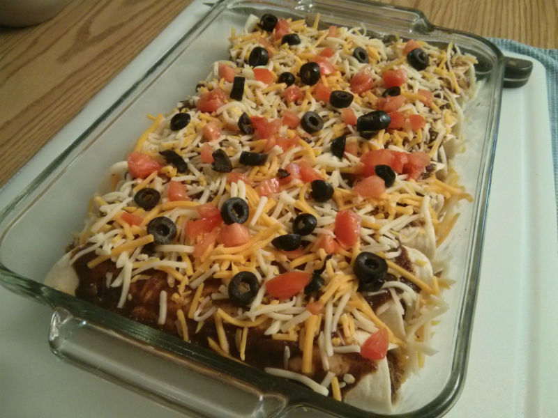 Add cheese, tomatoes and black olives