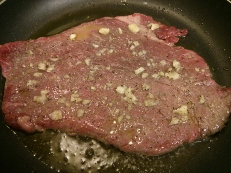 Palomilla Steak frying in skillet